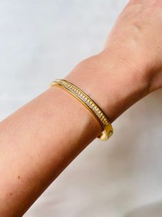 Stunning shiny Cubic Zirconia 18k gold plated bangle bracelet. Perfect for your bracelet stack collection. You can easily style it with every outfit day or evening, casual or occasional. Perfect piece to elevate your look! Made with most durable stainless steel material. So you could enjoy our creations for longest time. C A R E T I P S ✔️ Please remove jewelry before showering, swimming and sleeping. ✔️Avoid direct use of perfumes, lotions or other harsh chemicals on the item. ✔️Store in a cool dry place, ideally in a separate compartments to prevent scratching. ✔️Gently wipe jewelry with a polishing cloth to clean and maintain shine. Why jewelry is made from from Stainless steel? Stainless steel ranks 6th on the Mineral Hardness rank, while others such silver ranks at 2.5. That means sta Gold Plated Bangles, Minimal Style, Style Expert, Style Gift, Bracelet Stack, Stainless Steel Material, Steel Material, Minimal Fashion, Things To Buy