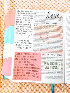 an open bible with the word love written in different colors and shapes on top of it