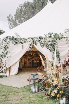 an outdoor tent set up with tables and chairs