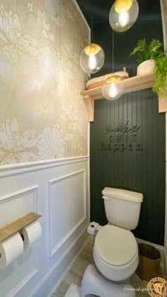 a white toilet sitting next to a green wall