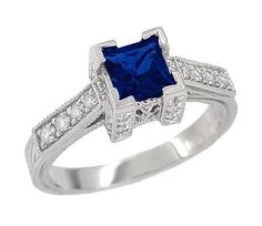 This unforgettable Art Deco filigree antique square blue sapphire engagement ring design is sure to attract admiration as it graces your hand. Artisan crafted in lavish platinum, this unique engagement ring features a splendid natural princess cut sapphire of 0.79 carat, set in an opulent filigree castle setting, with geometric artisan engraving on the outside of the band and shimmery beaded millgrain edging on the sides of the design. The castle setting is embedded with 24 round diamonds, and f Vintage Engagement Rings Simple, Antique Engagement Rings Sapphire, Vintage Inspired Engagement Rings, Vintage Engagement Rings Sapphire, Round Diamond Setting, Ceylon Sapphire, Simple Engagement Rings, Sapphire Engagement Ring Blue, Sapphire Engagement Ring