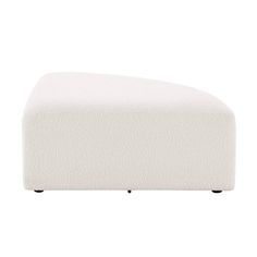 a white ottoman sitting on top of a wooden table