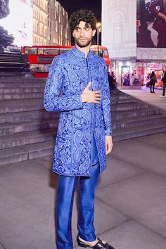 Blue sherwani features paisley pattern thread embroidery in tones of blue. Comes with a matching silk kurta and straight pant. - Aza Fashions Blue Bollywood Nehru Jacket For Reception, Bollywood Style Blue Nehru Jacket For Reception, Traditional Blue Bandhgala With Naqshi, Blue Bandhgala With Naqshi For Formal Occasions, Formal Blue Sherwani With Naqshi Detailing, Formal Blue Sherwani With Naqshi, Blue Bandhgala With Naqshi Traditional Drape, Blue Sherwani With Naqshi For Festive Occasions, Blue Naqshi Sherwani For Festive Occasions