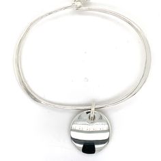 James Avery Sterling Silver Round Cabochon Hammered Hinged Charm Bangle Bracelet 15.4 Grams 20.0mm Size of Round Cabochon Charm 3.5mm Width of Hammered Flat Bangle Discover timeless elegance with our Sterling Silver Bangle Bracelet. Crafted with meticulous attention to detail, this bracelet features a hammered finish that catches the light beautifully. The hinged design ensures a comfortable fit, while the round cabochon charm adds a touch of sophistication. Perfect for both casual and formal occasions, it's a versatile piece that complements any outfit. Elevate your style with this exquisite bracelet." Modern Silver Bracelets With Charms, Sterling Silver Adjustable Bracelet With Polished Finish, Modern Engraved Round Bracelet, Adjustable Silver Charm Bracelet With Oyster Design, Modern Adjustable Nickel-free Charm Bracelet, Modern Adjustable Nickel Free Charm Bracelet, Adjustable Silver Bangle With Charms, Adjustable Modern Bangle, Modern Adjustable Round Bangle