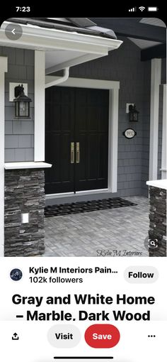 a black front door on a gray house