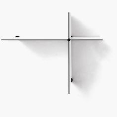 a white wall with a black cross on it