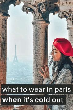 a woman wearing a red hat standing on top of a building with the words what to wear in paris when it's cold out