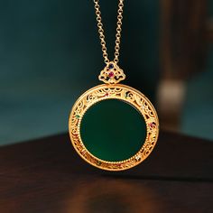 This Clouds Jade Plate Pendant Necklace is made with exquisite craftsmanship for a delicate and elegant look. It is crafted with one-of-a-kind natural jade stones to ensure long-lasting wear and unique beauty. This special necklace makes a perfect gift for any special occasion.

Natural emerald Jade stone
Chain length: 45 CM (+ 5 cm adjustable chain)
24K gold
Pendant size: 34*42mm
Adjustable lobster clasp size - one size fits all
Hypoallergenic, lead and nickel free

If you aren't in LOVE with y Jade Clavicle Chain Pendant Jewelry, Jade Clavicle Chain With Round Pendant, Spiritual Jade Jewelry Gift, Spiritual Jade Jewelry For Gifts, Jade Pendant Necklaces For Crafting, Gold Jade Round Pendant Necklace, Green Round Necklace Gift For Her, Gold Jade Necklace With Round Pendant, Elegant Green Necklaces With Natural Stones