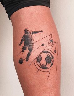 a person with a soccer tattoo on their leg and the ball is flying through the air