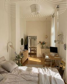 a bed sitting in a bedroom next to a desk and tv on top of a hard wood floor