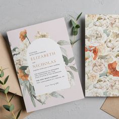 two wedding cards on top of envelopes next to each other with flowers and leaves