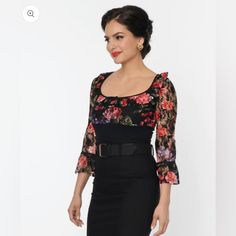 This Sultry Blouse Is Crafted In A Fabulous Black Sheer Stretch Lace Boasting Colorful Florals Throughout. The Scoop Neckline Is Elegantly Framed By Frilled Three-Quarter Length Empire Sleeves. Perfect For Pairing With Your Favorite Bottoms! Imported Shell: 95% Cotton, 5% Spandex ; Contrast: 100% Polyester Hand Wash Cold, Flat Dry Unlined Material Has Stretch & Is Sheer Length Measured From Side Model Pictured Wearing Size M; M Length 20.5" Model Info: Height: 5'9 Waist: 28.5" Hips: 39" Bust: 34 Chic Fitted Sheer Blouse, Feminine Fitted Top For Night Out, Elegant Bodycon Tops For Night Out, Sheer Fitted Blouse, Feminine Fitted Blouse For Party, Feminine Fitted Blouse For Night Out, Elegant Bodycon Top For Date Night, Feminine Fitted Blouse For Date Night, Elegant Bodycon Party Tops