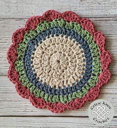 a crocheted doily is shown on a wooden surface