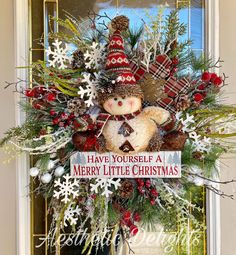 a christmas wreath with a teddy bear on it