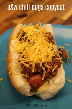 a hot dog covered in chili and cheese on a blue plate with text overlay