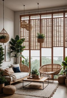 a living room filled with furniture and lots of plants in front of large windows that look out onto the outdoors