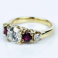 three stone diamond and ruby ring in yellow gold