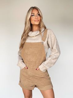 Experience sophisticated style with our luxurious Corduroy Shortalls. Crafted from soft and sumptuous corduroy, the classic square neckline and neatly folded hem exude refined elegance. Enjoy pocket details, adjustable straps, and subtle button closure details for all-day comfort and cosy transitions from summer to fall. Layer up and experience the perfect pumpkin patch to apple picking piece for an elevated and trendy look. 98% Polyester 2% Spandex Hand wash cold. Fall Overalls With Adjustable Straps, Fall Bib Front Overalls With Adjustable Straps, Fall Corduroy Overalls For Workwear, Fall Corduroy Workwear Overalls, Fall Bib Front Overalls With Suspenders, Chic Overalls With Pockets For Fall, Fall Workwear Shortalls, Fall Overalls With Suspenders For Workwear, Fall Workwear Overalls With Suspenders