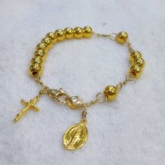 This bracelet has designed by Korea catholic person for her husband. She sugested all destails including cross and miraculous pendant. 24k gold 7mm ball has weaved by 18k solid gold wire and 18k gold chains. For the safety reason, 18k gold clasp & 18k gold chain has to be used. Customer can select different style and any changes is possible. Short wrist cannot use 15 pcs of 24k gold ball but 11 pcs is suitable. I do not accept off-site ads order. * Material : 24K Solid gold & 18k solid g Spiritual Gold Hypoallergenic Jewelry, Gold Charm Bracelet With 8mm Beads As Gift, Gold Rosary Bracelet With Gold Beads As A Gift, Handmade Gold Bracelet With Round Beads, Gold Jewelry With 8mm Beads In 14k Gold Filled, Gold Beaded Bracelets With Charms, Spiritual Rosary Bracelet With Gold Beads As Gift, Spiritual Gold Beaded Bracelets With Charms, Gold Beaded Bracelets With Charms And Round Beads