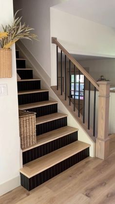 there is a basket sitting on the stairs next to the banisters in this house