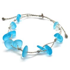 Gorgeous beach bracelet or anklet made with turquoise blue and white sea glass pebbles on our durable hand spun rope cord. Pure island style! Easy and secure adjustable slide knot closure allows for easy on and off. This bracelet/anklet is completely waterproof and metal free making it perfect for anyone with skin sensitivities and is a wonderful and unique gift for those hard to shop for friends and family on your list, especially the beach lovers! Color: Turquoise blue Size: Available in three Adjustable Strand Jewelry With Sliding Knot, Hand Wrapped Braided Bracelets With Round Beads For Beach, Beach Braided Bracelets With Round Beads, Turquoise Jewelry With Adjustable Cord For Beach, Adjustable Blue Beachy Jewelry, Blue Adjustable Beachy Jewelry, Blue Resizable Braided Bracelets For Beach, Blue Resizable Braided Bracelet For Beach, Beach Braided Bracelet With Round Beads And Sliding Knot