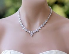 a woman wearing a diamond necklace on her neck