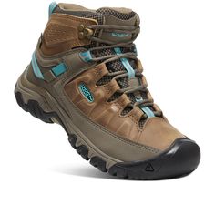 the women's waterproof hiking boot is shown in brown and blue, with black outs