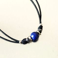 Mens necklace made of natural lapis lazuli stone bead on black wax cotton cord, lobster clasp closure. One stone bead choker necklace minimalist style, every day choker necklace for him. Blue stone bead rope choker necklace.  A nice gift for him. All metal components are stainless steel. Lapis lazuli bead: 7 mm For all products are used only genuine high-quality Italian leather, natural stones and wood. All metal materials are lead and nickel free.  /Gift wrapping and packaging/ :   All items or Minimalist Adjustable Lapis Lazuli Jewelry, Adjustable Minimalist Lapis Lazuli Jewelry, Minimalist Blue Jewelry With Adjustable Length, Blue Beaded Jewelry With Adjustable Cord, Minimalist Jewelry With Adjustable Waxed Cord, Handmade Minimalist Jewelry With Waxed Cord, Adjustable Blue Waxed Cord Jewelry, Blue Adjustable Waxed Cord Jewelry, Minimalist Adjustable Waxed Cord Jewelry