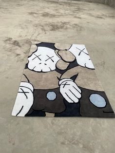 a rug with mickey mouse on it in the middle of an empty parking lot,