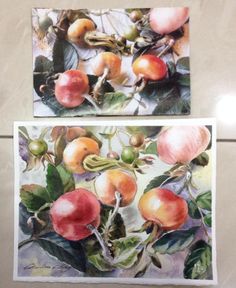 two paintings of apples hanging on the wall