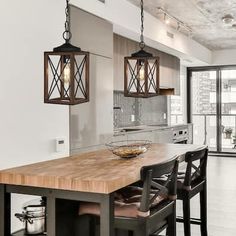 a kitchen with an island and two pendant lights