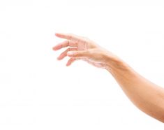 a person's hand reaching out to touch something in the air on a white background