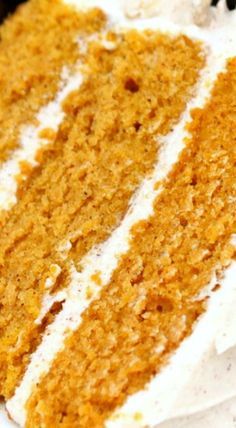 a slice of carrot cake with white frosting