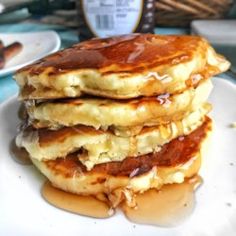 three pancakes stacked on top of each other with syrup drizzled over them