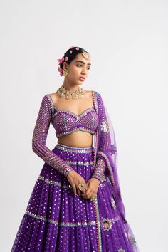 Intricately hand embroidered multi color sweetheart blouse with multi tier hand embroidered lehenga and a beautiful mirror work dupatta.From Vvani Vats Rang's collection.DELIVERY TIMEPlease allow 8-12 weeks for your outfit to arrive.FABRIC DETAILSNet, Georgette, Silk BlendProfessional cleaning only. Designer Multicolor Pre-draped Saree With Gota Work, Designer Purple Choli With Gota Work, Purple Pre-draped Saree With Mirror Work For Navratri, Navratri Purple Pre-draped Saree With Mirror Work, Party Choli With Multicolor Embroidery And Mirror Work, Purple Anarkali Pre-draped Saree With Mirror Work, Designer Multicolor Embroidered Lehenga With Gota Work, Purple Sequined Traditional Wear For Diwali, Purple Sequins Sets For Navratri