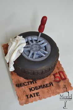 a cake made to look like a tire with a flag sticking out of the tire