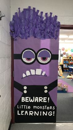 a purple door decorated with an angry minion saying beware little monsters learning