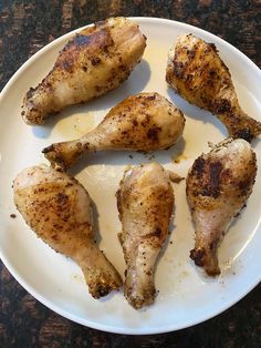 four pieces of chicken on a white plate