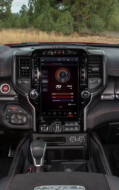 the interior of a vehicle with dashboard, steering wheel and touch screen showing various functions