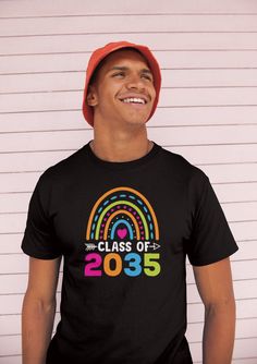 a man wearing a black class of 2013 t - shirt with rainbows on it