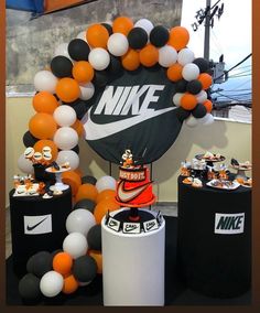 an assortment of balloons and decorations for a nike event