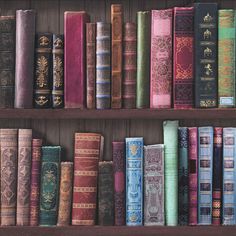 an old bookshelf filled with lots of different colored books on top of wooden shelves