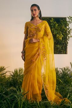 Yellow silk organza placement embroidery silk organza saree. Comes with an elbow sleeve silk chanderi blouse. - Aza Fashions