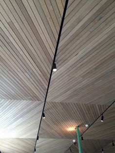 the ceiling is covered with wooden planks and lights