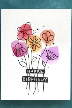 a card with watercolor flowers on it and the words happy birthday written in black ink