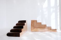 a set of wooden stairs next to a white wall