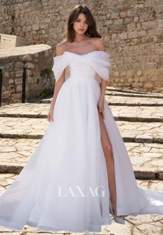 a woman in a white dress standing on some steps with her leg up and wearing high heels