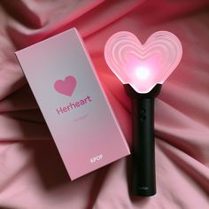 a pink heart shaped light is next to a box