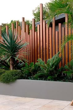 an outdoor garden with wooden slats and plants on the sides, along with a lawn chair