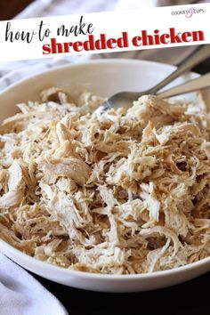 shredded chicken in a white bowl with a spoon and napkin next to it on a table